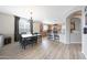 Open concept dining area with hardwood floors and view into the kitchen area at 16039 W Pima St, Goodyear, AZ 85338