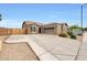 Inviting home featuring desert landscaping, a two-car garage, and a welcoming entrance at 16039 W Pima St, Goodyear, AZ 85338