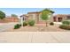 Beautifully landscaped front yard featuring a decorative rock stream and mature trees at 16039 W Pima St, Goodyear, AZ 85338