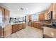 Spacious kitchen featuring hardwood floors, stainless steel appliances and view to dining area at 16039 W Pima St, Goodyear, AZ 85338
