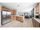 Open concept kitchen with hardwood floors and view into the dining and living areas at 16039 W Pima St, Goodyear, AZ 85338