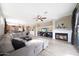 Spacious living room boasts a cozy fireplace, ceiling fan, and comfortable seating at 16039 W Pima St, Goodyear, AZ 85338