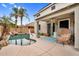 This backyard features a pool, covered patio, ceiling fan, lounge seating, and palm trees at 16139 N 171St Ln, Surprise, AZ 85388