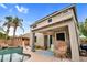 This backyard features a pool, covered patio, ceiling fan, lounge seating, and palm trees at 16139 N 171St Ln, Surprise, AZ 85388