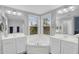 Bright bathroom featuring dual sinks, a tub, and a large window at 16139 N 171St Ln, Surprise, AZ 85388