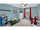Bedroom featuring a ceiling fan, blue accent wall, and plush carpet at 16139 N 171St Ln, Surprise, AZ 85388