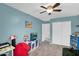 Bedroom features a ceiling fan, blue accent wall, and plush carpet at 16139 N 171St Ln, Surprise, AZ 85388