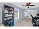 This loft/bedroom has comfortable carpeting, a ceiling fan, and a built-in bookcase for added storage at 16139 N 171St Ln, Surprise, AZ 85388