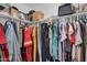Walk-in closet with rods full of organized clothing at 16139 N 171St Ln, Surprise, AZ 85388
