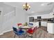 This charming dining area has a retro table and chairs, with a view of the modern kitchen at 16139 N 171St Ln, Surprise, AZ 85388