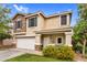Inviting two-story home with stone facade, covered porch, and colorful landscaping at 16139 N 171St Ln, Surprise, AZ 85388