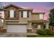 Charming two-story home featuring a stone facade, well-manicured lawn and an attached two-car garage at 16139 N 171St Ln, Surprise, AZ 85388