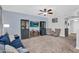 This living room has a large seating area, tv, ceiling fan and display cabinets at 16139 N 171St Ln, Surprise, AZ 85388