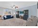 Bright living room features a large window, plush carpet, a TV, display cabinets and comfortable seating at 16139 N 171St Ln, Surprise, AZ 85388