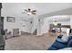 This living room has an open floor plan, plush carpet, and an archway to the dining area and kitchen at 16139 N 171St Ln, Surprise, AZ 85388