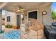 Cozy covered patio featuring a large wicker chair and outdoor furnishings, ideal for relaxing and entertaining at 16139 N 171St Ln, Surprise, AZ 85388