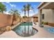Sparkling pool in a private backyard, featuring palm trees, rock features and a basketball hoop at 16139 N 171St Ln, Surprise, AZ 85388