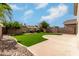A serene backyard featuring artificial grass, a concrete patio, and low-maintenance desert landscaping at 16424 S 46Th Way, Phoenix, AZ 85048