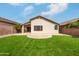 Well-maintained backyard featuring an artificial lawn, patio area, and privacy landscaping at 16424 S 46Th Way, Phoenix, AZ 85048