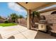 Spacious backyard with a covered patio, artificial turf, and a built-in stainless steel grill at 16424 S 46Th Way, Phoenix, AZ 85048