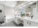 Bright bathroom showcasing a double sink vanity with sleek cabinets and a frameless shower at 16424 S 46Th Way, Phoenix, AZ 85048