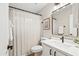 Neat bathroom featuring a white vanity, modern mirror, and a shower with a linen curtain at 16424 S 46Th Way, Phoenix, AZ 85048