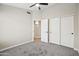 Spacious bedroom with ample closet space, a ceiling fan, and neutral carpeting at 16424 S 46Th Way, Phoenix, AZ 85048