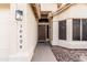 Close-up of the front entryway, featuring a stained front door, stylish wall lanterns, and well-maintained xeriscaping at 16424 S 46Th Way, Phoenix, AZ 85048