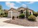 Single-story home with a two-car garage, xeriscaped front yard, and lush landscaping, creating curb appeal at 16424 S 46Th Way, Phoenix, AZ 85048