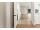 Inviting hallway showcasing neutral walls, tile flooring, and a seamless transition to the bright and open living spaces at 16424 S 46Th Way, Phoenix, AZ 85048
