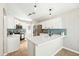 Stylish kitchen with white cabinets, blue subway tile backsplash, stainless steel appliances, and a quartz countertop island at 16424 S 46Th Way, Phoenix, AZ 85048