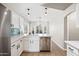 Well-lit kitchen showcasing stainless steel appliances, white cabinets, and a charming breakfast bar at 16424 S 46Th Way, Phoenix, AZ 85048