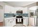 Beautiful kitchen featuring stainless steel appliances, ample white cabinetry, and stylish blue backsplash at 16424 S 46Th Way, Phoenix, AZ 85048