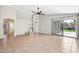 Open concept living room featuring tile floors, modern ceiling fan, and sliding glass door to outdoor patio at 16424 S 46Th Way, Phoenix, AZ 85048