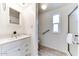Bright bathroom with white cabinets, a shower and a window with natural light at 17200 W Bell Rd # 1015, Surprise, AZ 85374