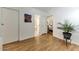 Bright hallway with wood-look floors leads to bathroom and bedroom at 17200 W Bell Rd # 1015, Surprise, AZ 85374