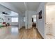 Hallway leads to living room, bedroom, and bathroom with hardwood floors at 17200 W Bell Rd # 1015, Surprise, AZ 85374