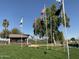 Picturesque park area with gazebo, pond, and flag poles flying various flags at 17200 W Bell Rd # 1015, Surprise, AZ 85374