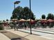 Residents enjoying the shuffleboard courts, shaded by umbrellas on a sunny day at 17200 W Bell Rd # 1015, Surprise, AZ 85374