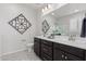 Bathroom featuring double sinks, patterned floor, and decor at 18247 W Soft Wind Dr, Surprise, AZ 85387