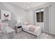 A darling bedroom with light walls, polka dots, and a cozy bed at 18247 W Soft Wind Dr, Surprise, AZ 85387