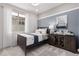 A charming bedroom with a blue accent wall and natural light at 18247 W Soft Wind Dr, Surprise, AZ 85387