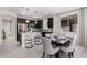 Modern kitchen with stainless steel appliances, dark cabinets, white countertops, and a dining area at 18247 W Soft Wind Dr, Surprise, AZ 85387