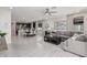 Open-concept living space with tile flooring, a dining area, and a modern kitchen with dark cabinetry at 18247 W Soft Wind Dr, Surprise, AZ 85387