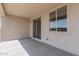 Covered patio featuring a seamless glass sliding door and adjacent window bringing the outdoors in at 18247 W Soft Wind Dr, Surprise, AZ 85387