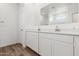 Clean bathroom featuring double sinks, white cabinets, and a large mirror at 18795 E Bruno Dr, Gold Canyon, AZ 85118