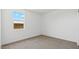 Empty bedroom with neutral carpet, a large window and white walls at 18795 E Bruno Dr, Gold Canyon, AZ 85118