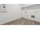 Functional laundry room with hookups, shelving, and wood-look flooring at 18795 E Bruno Dr, Gold Canyon, AZ 85118