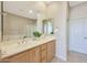 Bathroom with double vanity, decorative mirror, and a glass enclosed shower and bathtub at 20750 N 87Th St # 2062, Scottsdale, AZ 85255