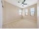 Bright bedroom with carpet, three windows and a ceiling fan with overhead lighting at 20750 N 87Th St # 2062, Scottsdale, AZ 85255